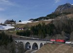 Am 27.02.2016 ziehen 1016 009 und 1144 235 leere Wagen der Gattung Laeks die Arlbergbahn Westrampe hinauf. In Dalaas wurde der Zug auf der Brcke ber den Hlltobel fotografiert.