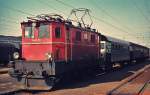 1045.03 im April 1975 mit einem Personenzug nach Kammer-Schörfling im Bahnhof Attnang-Puchheim
