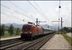 Die Ruhe vor dem Sturm: 1116 001 rast mit dem OEC 163  TRANSALPIN , Basel SBB - Wien Westbahnhof, durch den Haltepunkt Langkarpfen in Richtung Kufstein. (02.08.2009)
