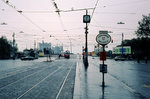 Wien am 31. Oktober 1976: Straßenbahnhaltestelle Mexikoplatz für stadtauswärts fahrende Züge der Linien B, BK, 25 und 26. In der Haltestelle für die stadteinwärts fahrende Züge der selben Linien hält eine E1+c2/c3-Garnitur, die kurz vorher über die Notbrücke, die in kurzer Zeit als Ersatz für die am 1. August 1976 eingestürzte Reichsbrücke errichtet worden war, gefahren war. - Am Ende der Straße stehen einige Leute, die an die Reste der eingestürzten Reichsbrücke schauen. - Scan von einem Diapositiv. Film: Agfachrome 50. Kamera: Leica CL. 