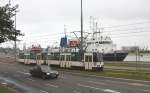 Drei Verkehrsgattungen auf einen Streich! Die alte polnische Konstal Tram fhrt hier  am 2.6.2013 gerade die Hafenstrae in Stettin entlang und passiert dabei  das am Kai liegende Schiff der Marine