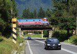 Diese Eisenbahnbrücke über der Nationalstraße 1 zwischen Brasov und Predeal wird am 28.08.2016 von der 0 40-1021-7 und einem kurzen Güterzug durchfahren.