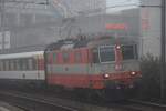 Re 4/4 II 11108  Swiss Express  zieht am 14.10.2017 in Brugg den Interregio nach Zürich HB aus dem Nebel in Richtung Baden.