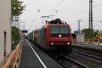 Durchfahrt am 18.04.2014 von Re 482 023-9  fährt für SBB Cargo International  mit einem Containerzug durch den Bahnhof von Müllheim (Baden) gen Norden.