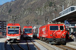 MGB: Grosser Bahnhof Brig vom 26. März 2016 mit HGe 4/4 II 106  GLACIER EXPRESS vor dem GLACIER EXPRESS , R nach Zermatt mit ABDeh 4/10 sowie abgestellte Reservekomposition mit ABDeh 4/8.
Foto: Walter Ruetsch 