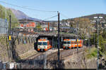 Bahnhof Lugano FLP mit abgestelltem Mandarinli Be 4/8 41 und aus Ponte Tresa ankommendem Mandarinli Be 4/12 24 am 6. April 2021.
