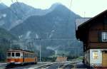 Be 4/4 133 der GFM steht kurz nach einem heftigen Sommergewitter abfahrbereit im Bahnhof Montbovon (Juli 1983)