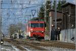 Die HGe 4/4 101 961-1 wartet am 5. Februar 2011 in Meiringen auf ihren IR 2219 nach Luzern, der sich im Hintergrund schon nhert.