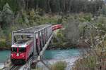 Zwischen den Stationen Versam-Safien und Trin berquert Ge 4/4 II 633 'Zuoz' mit dem RE 1257, Disentis/Mustr - Scuol-Tarasp, am 12.10.2014 den Vorderrhein.