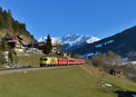 Ge 4/4 II 611 mit einem RE am 19.03.2016 bei Serneus.