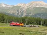 Zwischen Samedan und Pontresina, die Gterzug 5115 von Landquart bis Pontresina mit E-lok Ge 6/6 II 702 und die Traktor Tm 2/2 114 (im schlepp).

 21/06/2011 