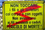 Warnungschild auf dem Gelnder einer Fussgngerbrcke ber die Bahnanlagen in Bodio (TI).