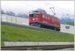 Ge 6/6 II 703  St.Moritz  als Lokzug nach Landquart passiert das Valserwasser-Verteillager in Untervaz-Trimmis. (05.04.2010)