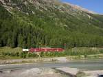 Allegra-Triebzug mit einem Gterwagen fhrt als R 1628 von Poschiavo nach St. Moritz am 20.08.2012 zwischen den Stationen Morteratsch und Surovas Richtung Pontresina.