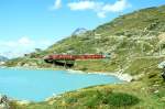 RhB Regionalzug 454 von Tirano nach St.Moritz am 04.09.1997 auf Brcke am See am Lago Bianco zwischen Alp Grm und Ospizio Bernina mit Triebwagen ABe 4/4 II 43 - B 2252 - B 2462 - B 2460 - DZ 4037 -