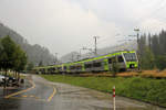 Die BLS in der grossen Hitze: Im Emmental bricht auf jeden Fall am Nachmittag ein heftiges Gewitter los. Durch Platzregen, Blitz und Donner kommen von Luzern her zwei Vierwagen-Triebzüge; der vordere ist eine BLS NINA (Nr. 28), der hintere ein BLS Lötschberger (Nr. 111). Trubschachen, 6.August 2018  