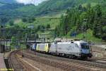 Hupac ES64U2 102 + NordCargo E189 923NC leading a southbound freight train just out from Gotthard tunnel in Airolo on the 21th of June in 2008