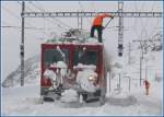 strecke-berninabahn-sm-ti Gem 4/4 801 'Steinbock' wird noch in Ospizio Bernina von seiner Schneelast befreit nach dem Schleudereinsatz. (01.12.2009)