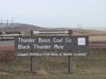 A Burlington Northern SD70MAC heads past the sign at the Thunder Basin Coal Co. near Wright, Wyoming, Nov 2003.