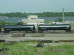 New tank cars fresh from the factory in 2003 roll through the Burlington, Iowa yard. Mississippi River in background.