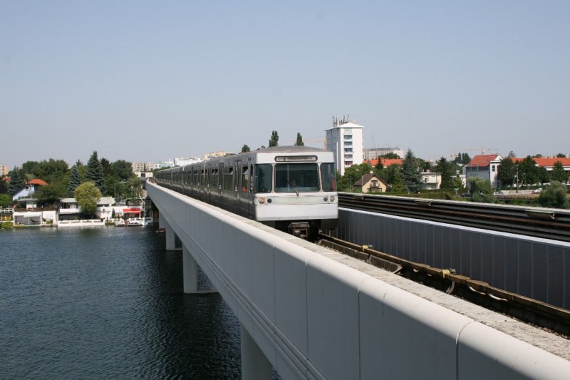 A U-Bahn U1 travels across the Danube to the station