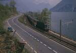 SBB Re 6/6 11634 'Aarburg-Oftringen' mit Intercity zwischen Lugano und Melide am 18. April 1989.