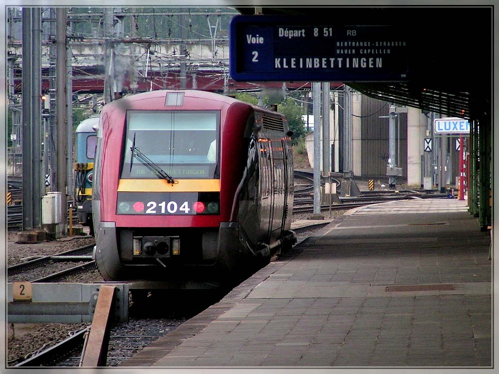 - Aus dem Archiv - Der Dieseltriebzug 2104 verlsst am 19.09.2004 den Bahnhof von Luxembourg in Richtung Kleinbettingen. Sowohl der Triebzug, als auch das Bahnsteigsdach sind mittlerweile Geschichte. (Hans) 