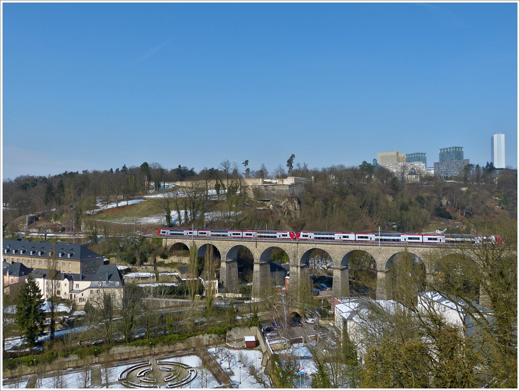 . Pfaffentaler Viadukt – Auch in der Stadt Luxemburg waren am 15.03.2013 noch Schneereste zu sehen, als eine Doppeleinheit Z 2200 das Pfaffentaler Viadukt in Richtung Norden gefuhr. Von den vier Eisenbahnbrcken in der Stadt Luxemburg, ist der Pfaffentaler Viadukt der zweitgrte, er hat eine Lnge von 257 Meter und besitzt 12 Bgen.

Im Hintergrund sieht man einerseits noch berreste der Festung Luxemburg (das Fort Thngen), andererseits das moderne Centre Europen auf dem Kirchberg.
(Jeanny)
