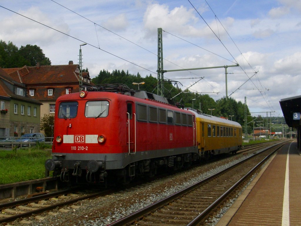 110 210-2 durchfhrt am 25. August 2010 mit einem Messwagen den Kronacher Bahnhof ber Gleis 4.