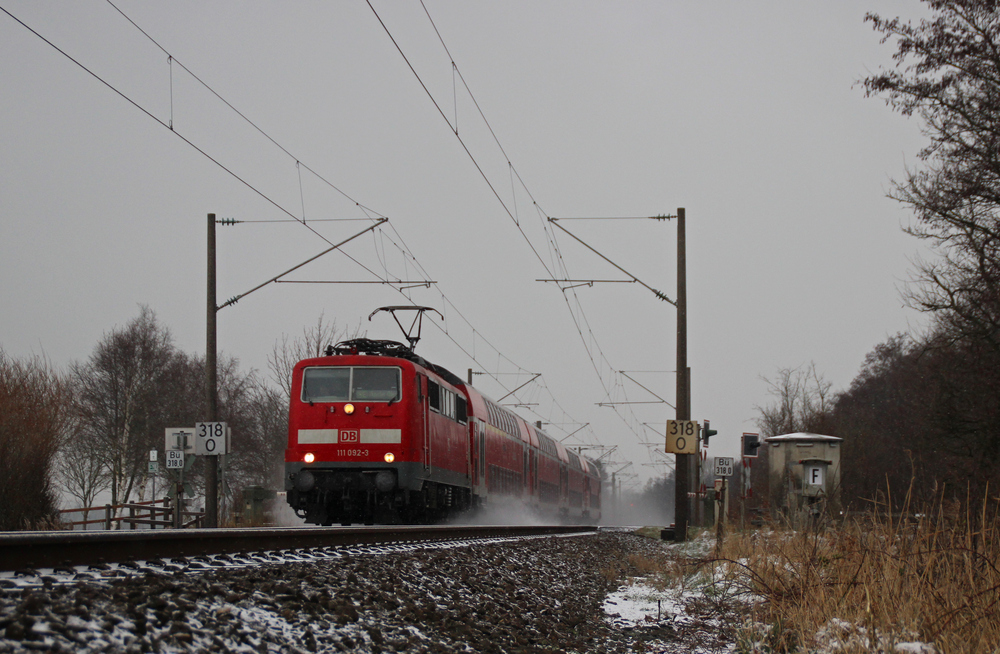 111 092-3 fuhr am 18.01.2013 mit einem RE von Emden nach Mnster, hier sdlich von Leer.