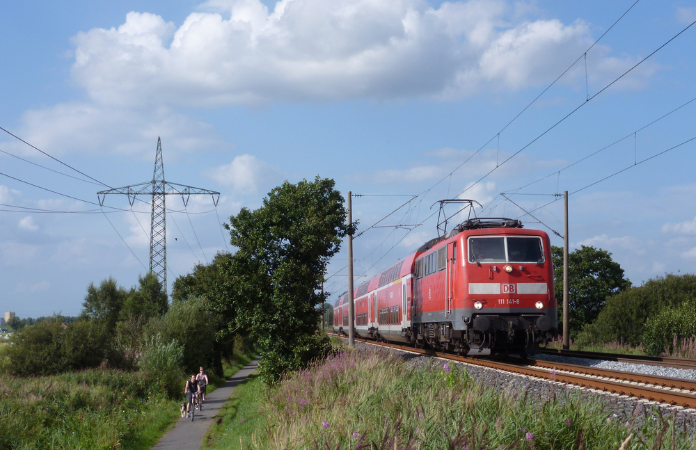 111 141-8 fuhr am 16.08.2012 mit einem RE von Emden nach Mnster, hier sdlich von Leer.