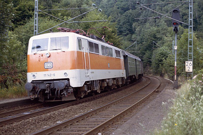 111 142-6 mit einem Eilzug, bestehend aus vierachsigen Umbauwagen, auf dem Weg von Hagen nach Siegen. Das Foto entstand 1982 in der Nhe von Altena.