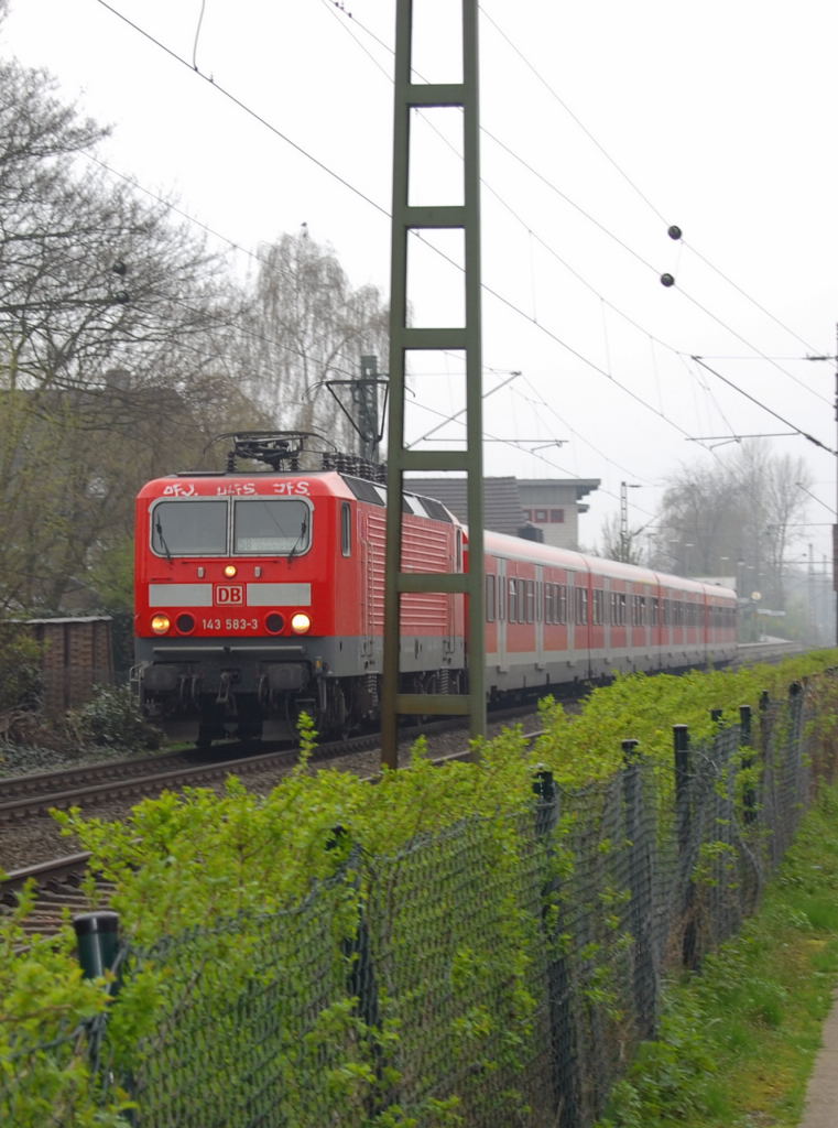 143 583-3 zieht einen S8-Zug nach Hagen, hier verlsst Sie gerade den Bahnhof Bttgen in Richtung Neuss Hbf bei diesigem Wetter.  8.4.2010
