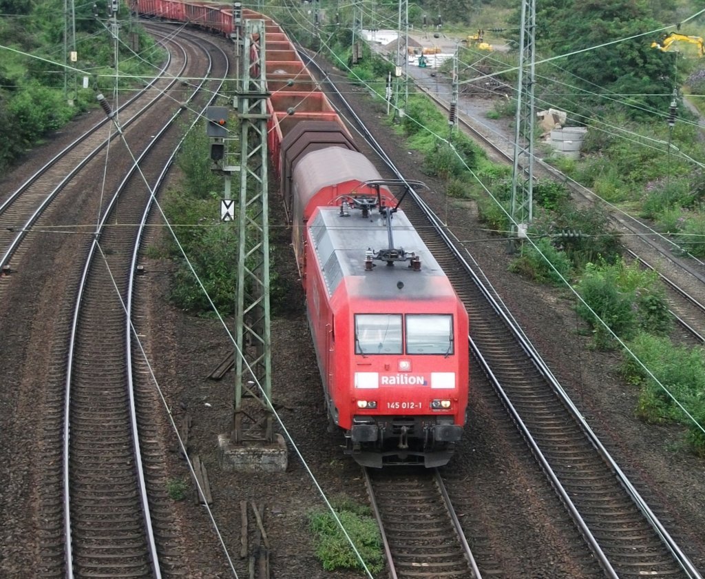 145 012 ist am 12.August 2011 mit einem Mischer in K�ln West unterwegs.