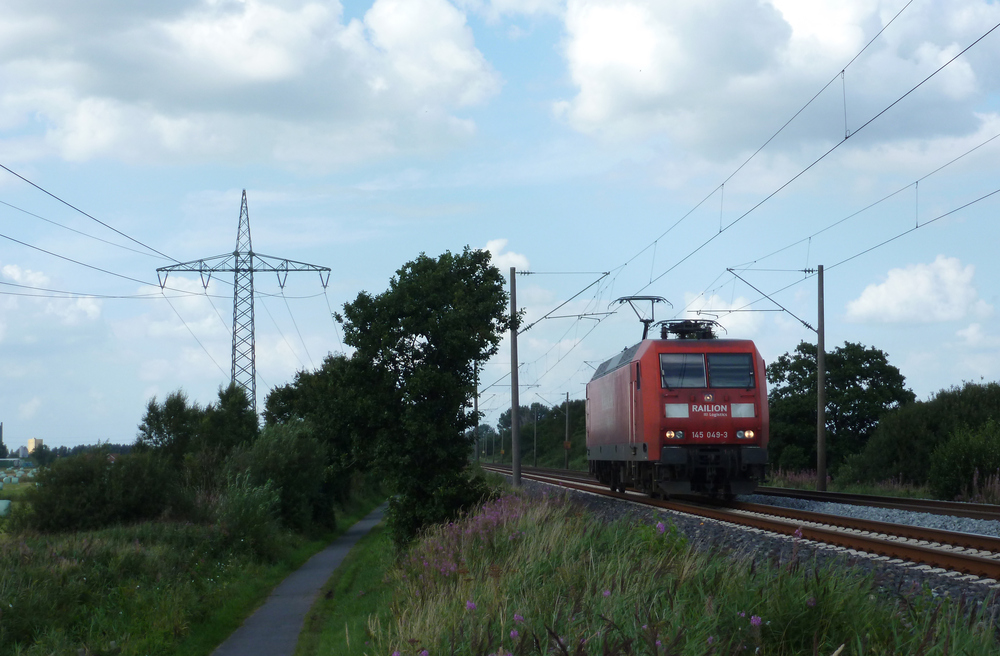 145 049-3 fuhr am 16.08.2012 als Lokzug von Emden nach Drpen, hier sdlich von Leer.