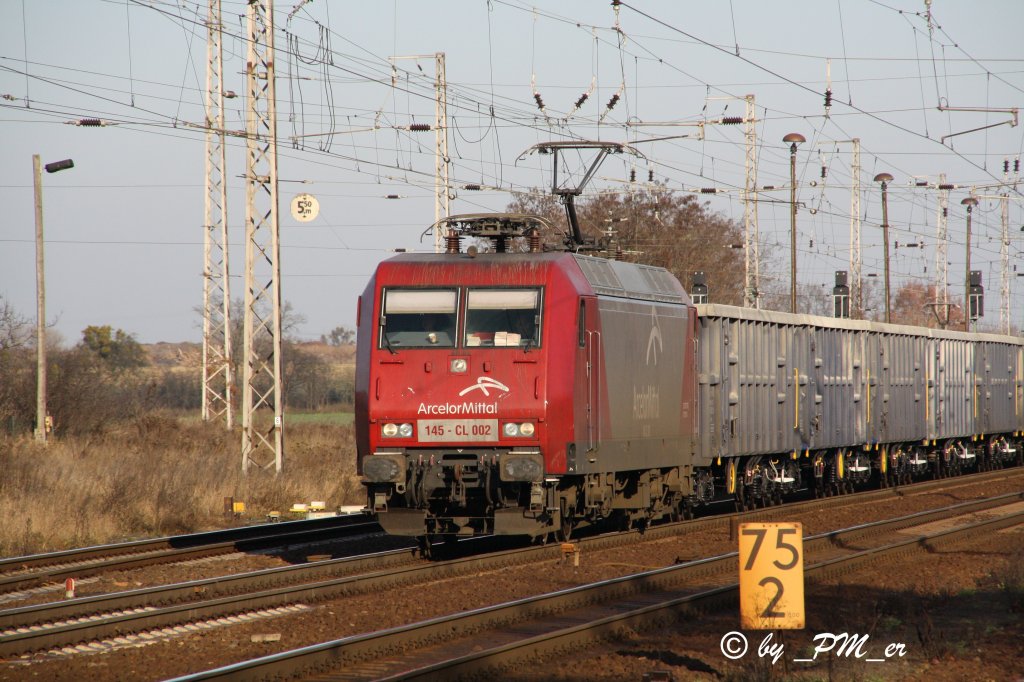 145-CL 002 der Arcelor Mittal Gruppe mit einem Ganzzug relativ neuer Wagen durchfhrt am 30.11.2011 Priort in Richtung Westen.
