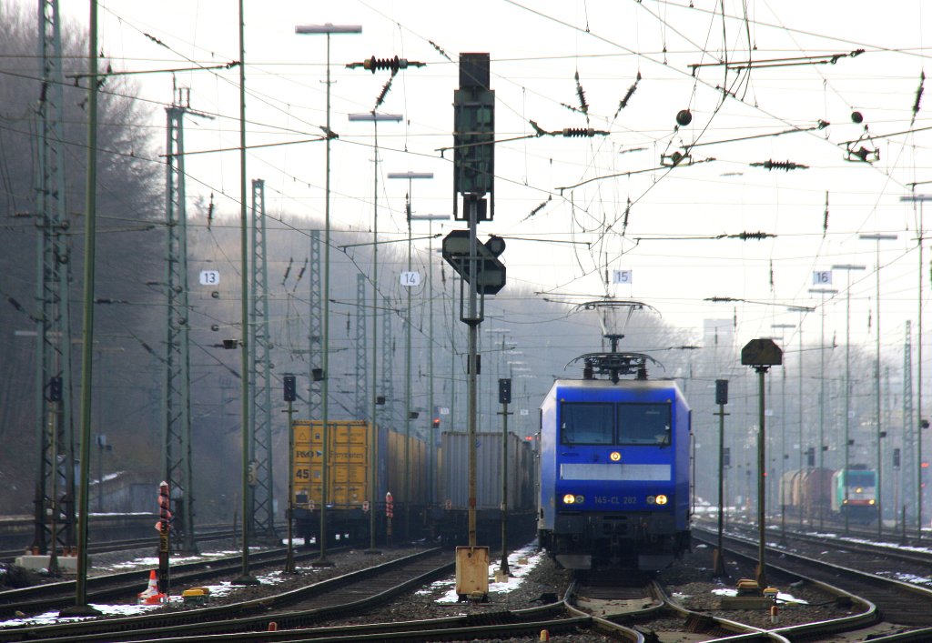 145 CL-202 von Crossrail steht in Aachen-West mit einem Langen Containerzug und wartet auf die Abfahrt in Richtung Kln und weiter nach Italien bei schnem vor  frhlingswetter am 2.3.2013.