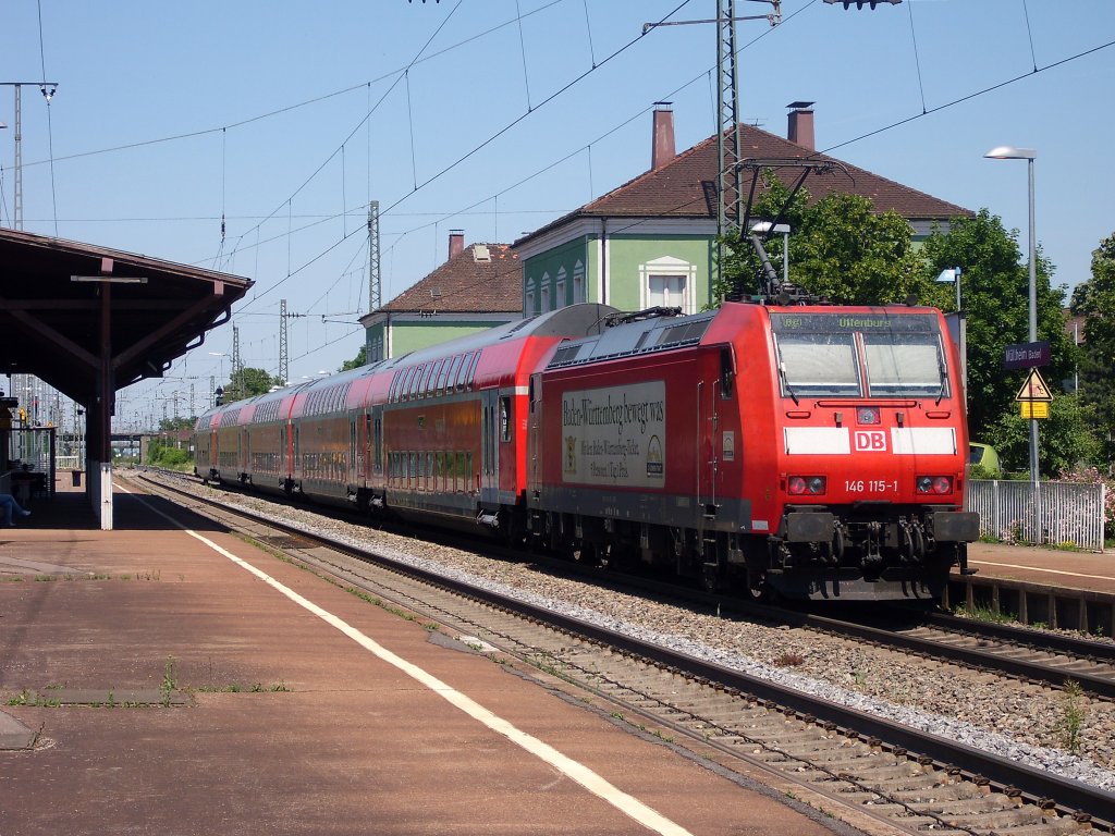 146 115-1 mit einem RE nach Offenburg am 30.05.11 beim Halt in Mllheim (Baden).