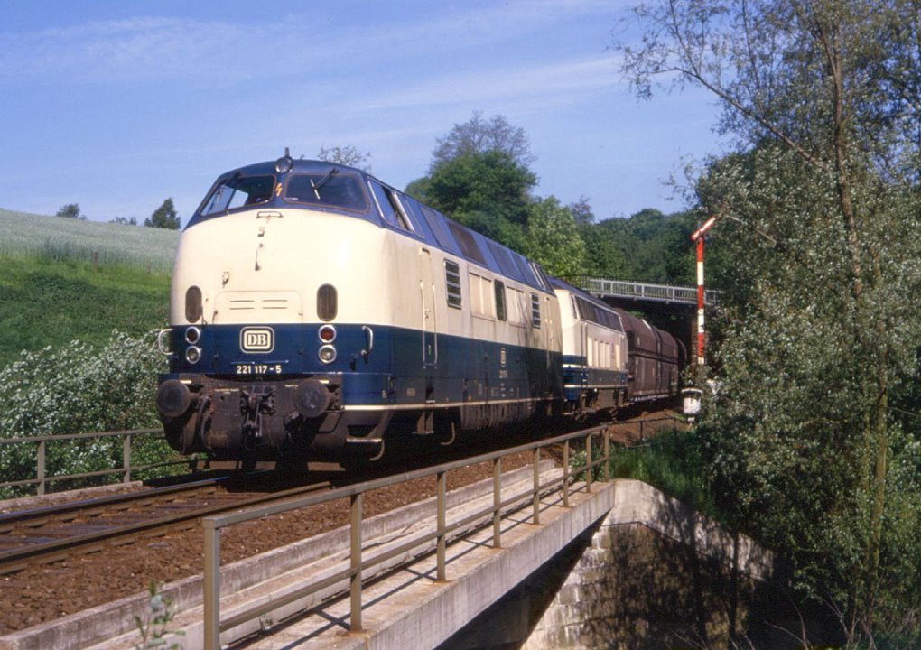221 117 und eine 215 am 18.05.1985 bei Heiligenhaus Hofermhle mit einem Leerzug fr die KAlkwerke Rohdenhaus.