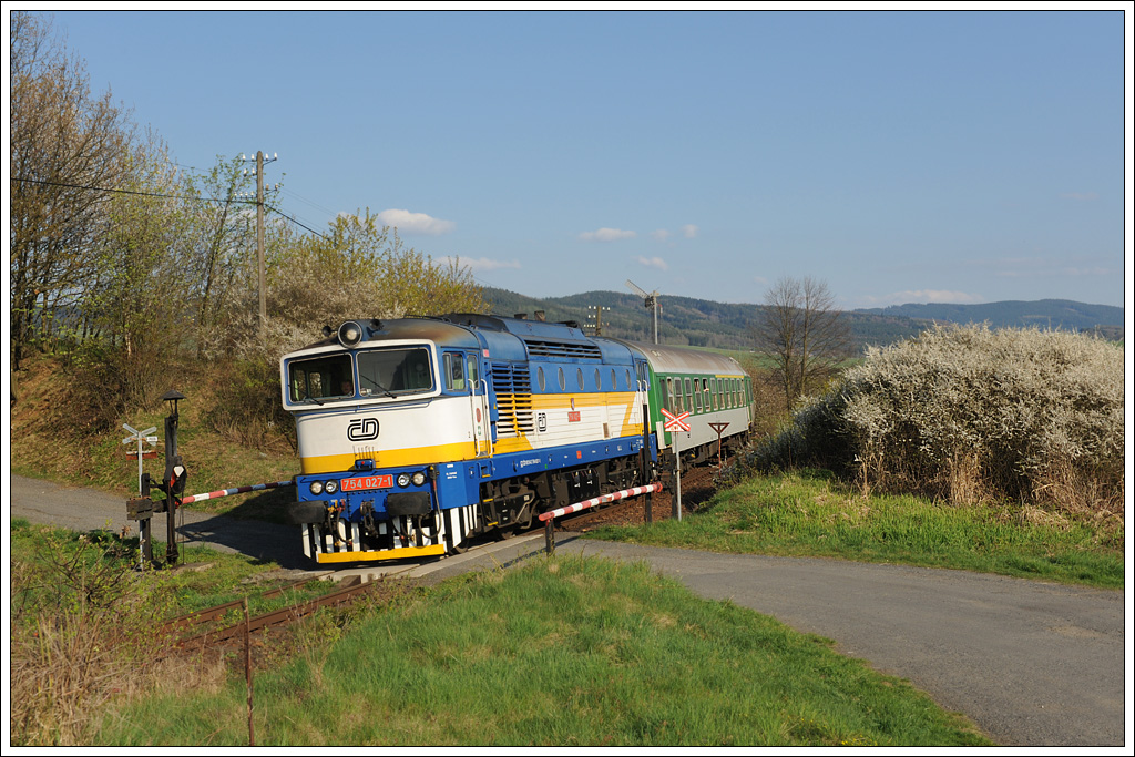 754 024 bespannte am 17.5.2011 bis Klatovy (deutsch Klattau) den R 827 von Bayerisch Eisenstein nach Praha hl.n. (Prag). Ab Klatovy bernimmt dann eine E-Lok diesen Zug. Die Aufnahme zeigt den Zug beim ES Nrsko (deutsch Neuern).