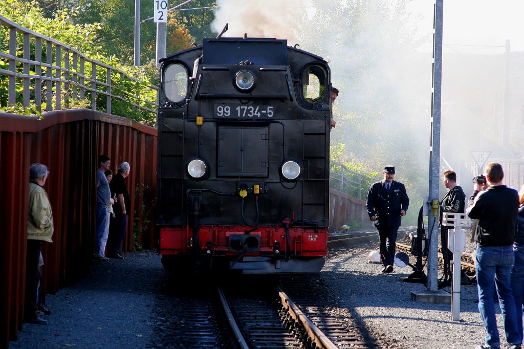 99 1734 am 09.10.2010 kurz vor der bernahme des Mittagszuges nach Dippoldiswalde im Bf Freital-Hainsberg. Der Herr in historischer Uniform (rechts neben der Lok),  ist Zugfhrer Patrick Wagner, welcher seinen Dienst auch im letzten Zug whrend der Hochwasserkatastrophe 2002, die zur nahezu vollstndigen Zerstrung der Gleisanlagen der Weieritztalbahn fhrte, versah! Da auch ich selbst mit meinen Freunden damals Fahrgast in jenem Zug war, mchte ich die Gelegenheit nicht versumen, darauf hinzuweisen, dass es nur dem umsichtigen Verhalten sowohl von Herrn Wagner als auch des Lokpersonals zu verdanken war, dass bei dieser Fahrt niemand zu Schaden kam! Nur kurze Zeit nach Ankunft unseres Zuges in Freital-Hainsberg (die Rckfahrt von Dippoldiswalde geriet zu einem wahren Abenteuer!), wurden Gleisanlagen und Brcken von der gewaltigen Flutwelle der Weieritz hinweggerissen und in ihre Bestandteile zerlegt! Nochmals ein groes Dankeschn an alle verantwortlichen Eisenbahner dieses Tages! Da habt Ihr wirklich Groes geleistet!!
In dankbarer Erinnerung und mit lieben Gren!
Michael Edelmann