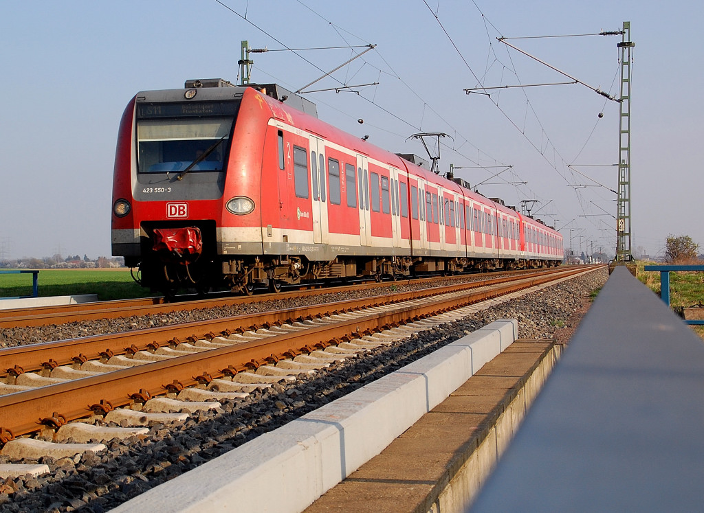 Als F�hrungsfahrzeug kommt der 423 550-3 an der Br�cke �ber die K33 bei Neuss Allerheiligen auf der S11 nach D�sseldorfflughafen am 28.3.2012 herangeeilt, gleich verweilt er einige Minuten am Haltepunkt....