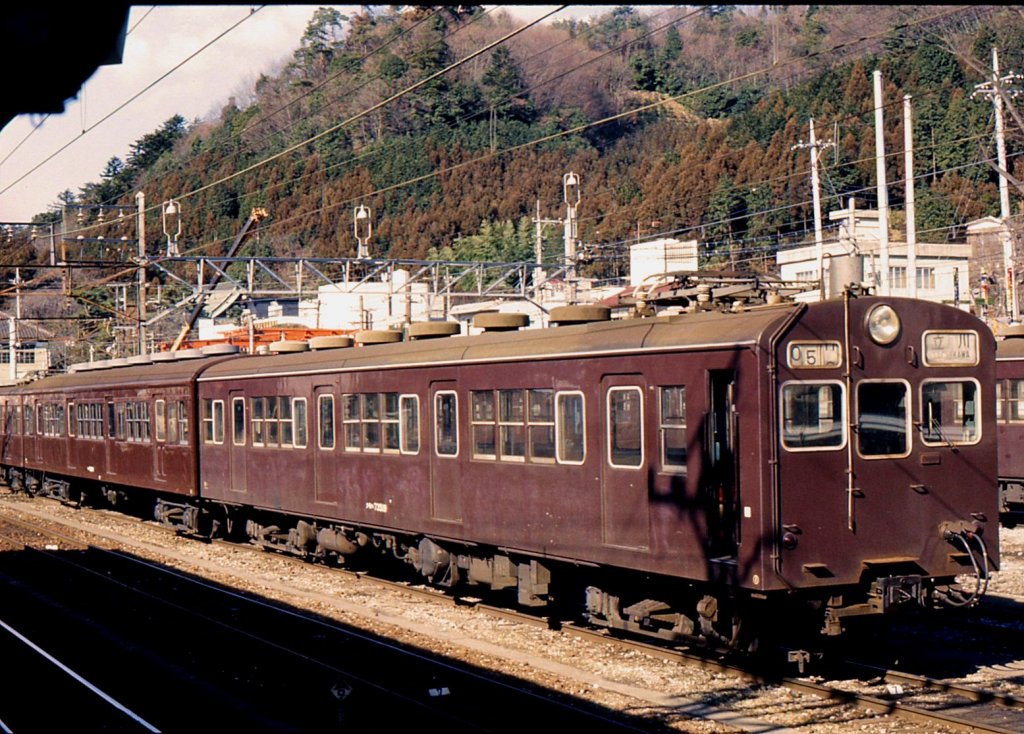 Altbautriebwagen ehemalige Staatsbahn JNR Serie 72: Gleichstromzüge ursprünglich für die S-Bahn, 1952-1958 entstanden. 20 m, 4-türig. Die Serie umfasst zahllose Untertypen aus verschiedensten Um- und Neubauaktionen; im Bild KUMOHA 73 519 (Motorwagen mit später angebautem Führerstand), links davon ein Zwischenwagen Typ SAHA 78. Ôme bei Tokyo, 29.Januar 1977. 