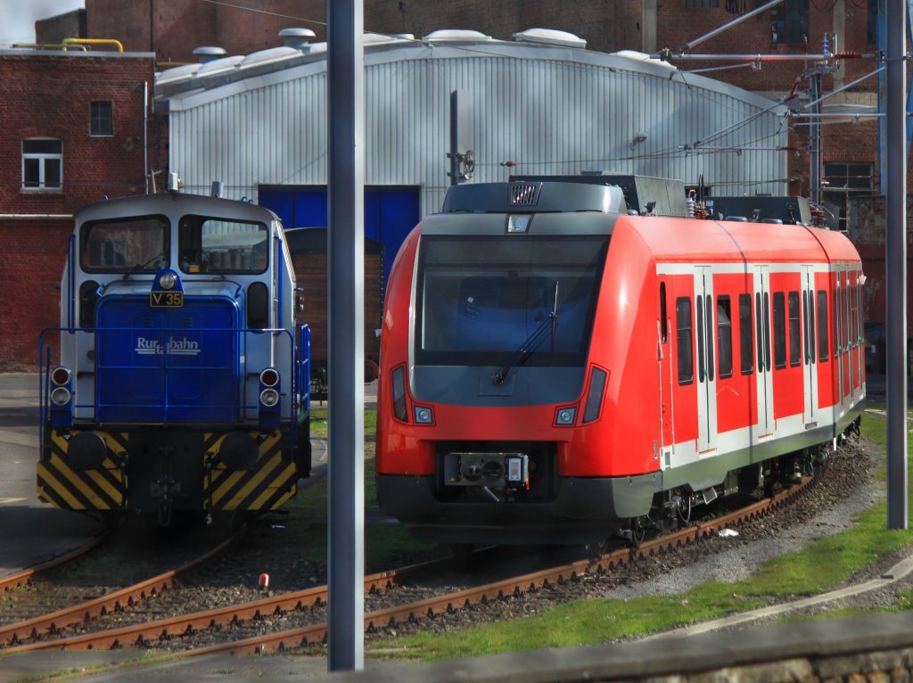 Am 27.03.2012 steht V35 der Rurtalbahn, eine MaK G 320 B, Bj.1968 neben einem neuen BR 430 S-Bahn-Triebwagen im Bombardier-Werk in Aachen. Der Triebzug hat noch keine Nummer, wird aber wahrscheinlich fr die S-Bahn Stuttgart gebaut worden sein. Dort sollen diese neuen S-Bahnzge die BR 420 ablsen. Das Bild wurde durch den Zaun von der Krantzstrasse aus gemacht.