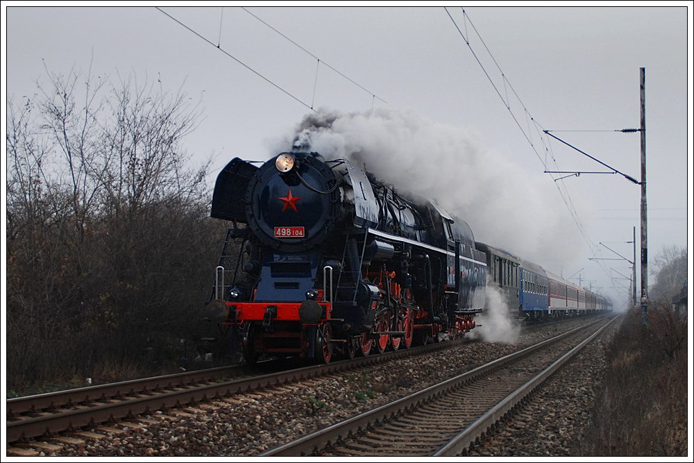 Am 6.12.2009 hatte 498.104 ihre erste ffentliche Ausfahrt nach ihrer Wiederaufarbeitung. Von Bratislava ausgehend ging es ber Kuty, durch die kleinen Karpaten nach Trnava  und ber die Hauptstrecke wieder retour nach Bratislava. Wegen ihres eleganten ueren erhielten sie vom Betriebsdienst den Spitznamen „Albatros jednička“, ich kann mich aber erinnern, irgendwann einmal gehrt zu haben, dass sie diesen Namen wegen ihrer Achsfolge 2´D 1 erhalten haben soll. Insgesamt wurden in den Jahren 1952-1954 fnfzehn Stck der Baureihe 498.1 in den Skodawerken in Pilsen gebaut. Die Baureihe 498.1 ist eine Weiterentwicklung der Baureihe 498.0, welche ebenfalls von Skoda in Pilsen in einer Stckzahl von 40 gefertigt wurde. Bis 1980 wurden alle Maschinen ausgemustert. Erhalten geblieben sind 498.104 als betriebsfhige Museumslokomotive in Bratislava Vchod, 498.106 in Brno und 498.112 im Eisenbahnmuseum Luna u Rakovnka. Die Aufnahme zeigt den Sonderzug zwischen Bratislava hl und Devnska Nov Ves.
