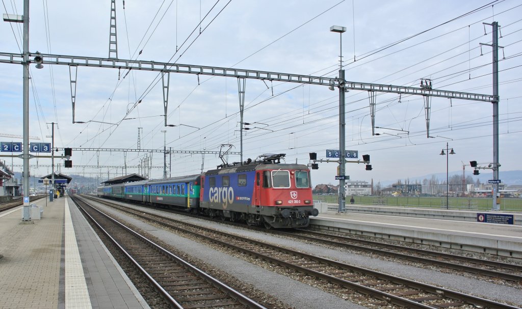 Auch auf der Linie Zrich-Chur wurden ICN fr den Autosalon abgezogen. Aus diesem Grund verkehrt als IC 10765/10790 eine Ersatzkomposition. Im Bild Durchfhrt die Re 421 392-2 mit 3 B EWII, A EWII und einem der letzten A EWIV in grn als IR 10765 den Bahnhof Pfffikon SZ, 07.03.2013.