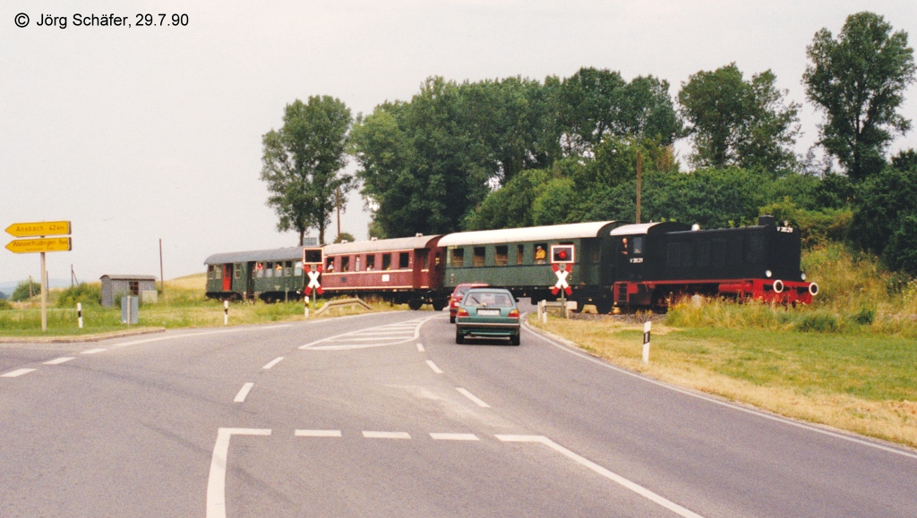 Bahn und Bundesstrae B 466 fhren zwar beide von Gunzenhausen nach Nrdlingen, verlaufen aber erst ab Hainsfarth parallel. Am Bahnbergang nrdlich von Hainsfarth trifft die vom Hahnenkamm kommende B466 auf die Bahnlinie aus dem Wrnitztal. (Blick nach Norden am 29.7.90)