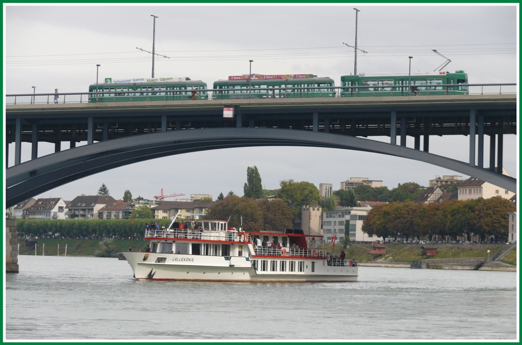 Be 4/4 + B4 + B4 berqueren den Rhein in Basel auf der Wettsteinbrcke. Auf dem Rhein kommt das Motorschiff  Llleknig  von der Schleusenfahrt nach Rheinfelden zurck. (117.09.2010)