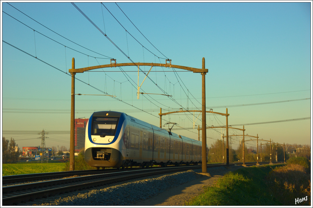 Bei herrlichem Wetter fhrt am Nachmittag des 14. Oktobers 2012 ein SLT-Triebzug als RB nach Breda unter den alten Fahrleitungsmasten bei Dordrecht.