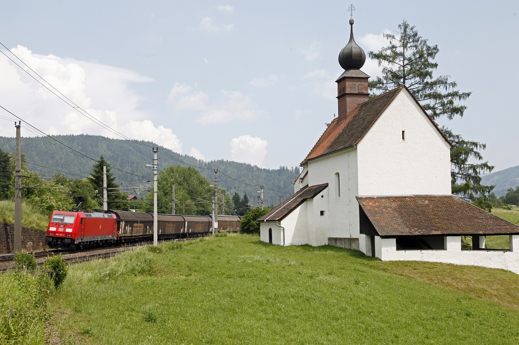 Bei der Walpurgiskirche in St.Michael schiebt am 18.06.2013 die 185 384 dem Zug 48930 nach.